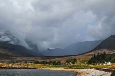 Scenic view of mountains against cloudy sky