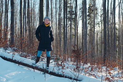 Full length of woman standing on snow covered land