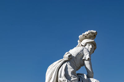 Low angle view of statue against clear blue sky