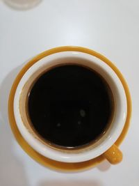 High angle view of black coffee on table