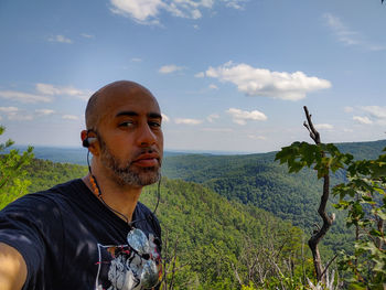 Portrait of young man against sky