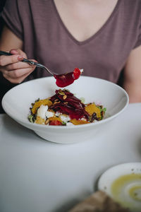 Midsection of woman holding ice cream in plate