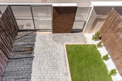 Exterior view of modern semi-detached townhouses with brick facade. sunny day