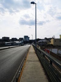 Street amidst buildings against sky in city