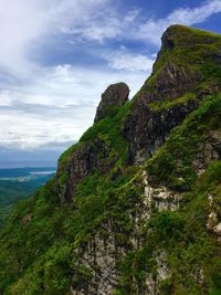 Scenic view of rocky mountains against cloudy sky