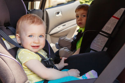 Portrait of cute boy sitting in car