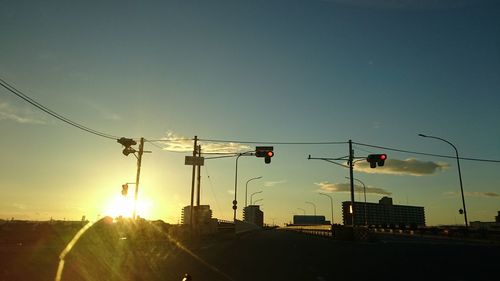 Vehicles on road at sunset
