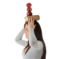 Woman holding umbrella standing against white background