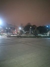 Illuminated street and buildings in city at night