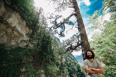 Portrait of man standing in forest