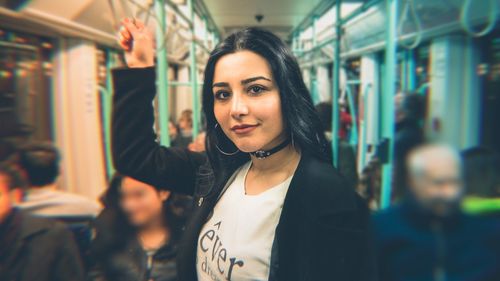 Portrait of beautiful woman standing at railroad station