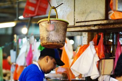 Man working with vegetables for sale at market stall