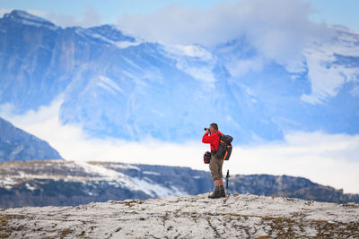 Man standing on snowcapped mountain