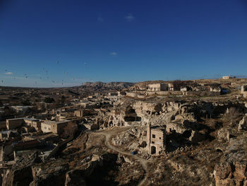 Aerial view of town against clear blue sky