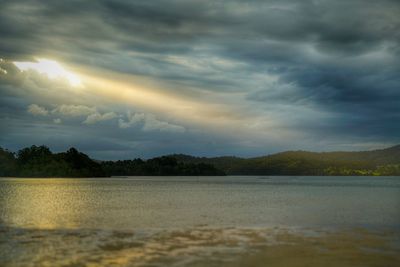 Scenic view of lake against sky at sunset