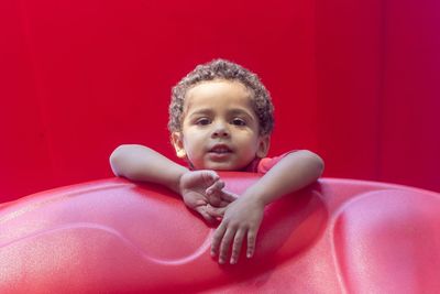 Portrait of boy playing on outdoor play equipment