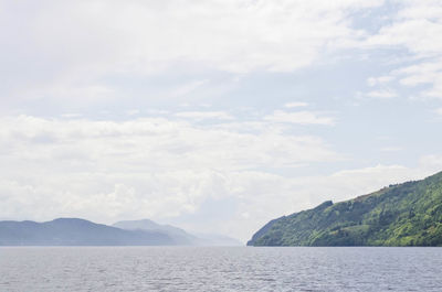 Scenic view of mountains against cloudy sky