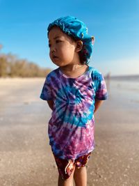 Portrait of cute girl standing on beach