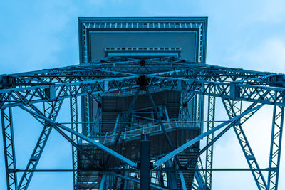 Low angle view of metal tower against sky
