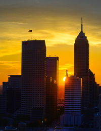 Low angle view of modern buildings against sky during sunset