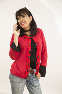 Portrait of smiling young woman against white background