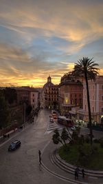 High angle view of road by buildings against sky during sunset