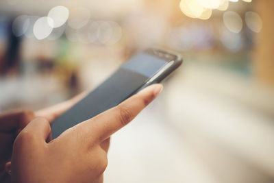 Midsection of man using mobile phone