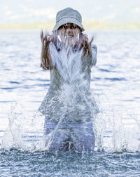 Portrait of woman standing in sea