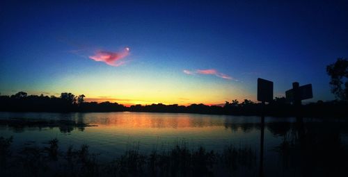Scenic view of calm lake at sunset