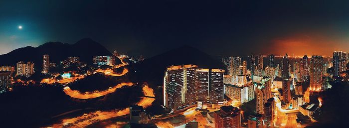 High angle view of city lit up at night