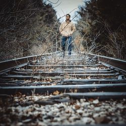 Man standing on railroad track