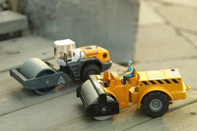 Close-up of toy steamrollers on table