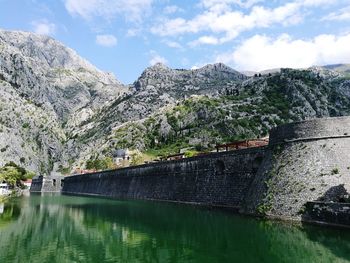 Low angle view of bay of kotor mountains against sky