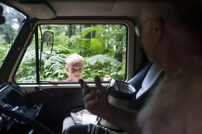 Portrait of man sitting in car