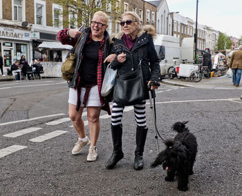 Woman with dog on street in city
