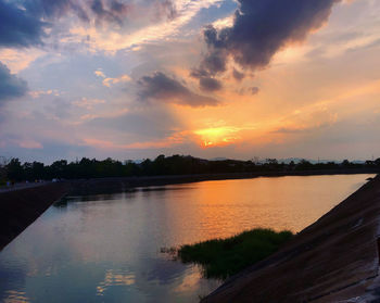 Scenic view of lake against orange sky