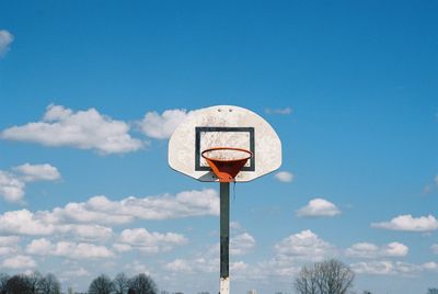 Low angle view of basketball hoop against blue sky