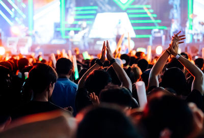 Rear view of people enjoying at music concert