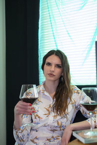 Young woman drinking glass with drink