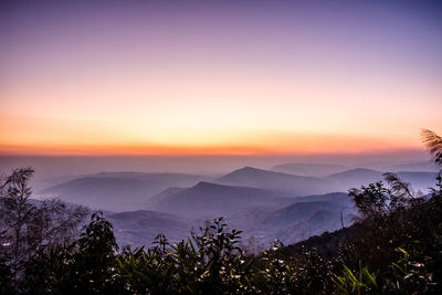 Scenic view of silhouette mountains against sky at sunset