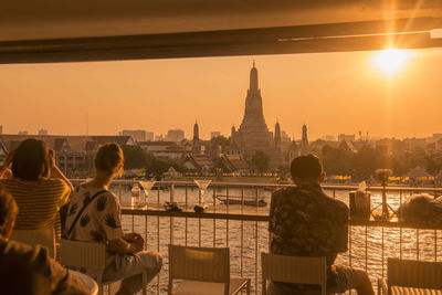 Rear view of man and woman looking at view of buildings in city