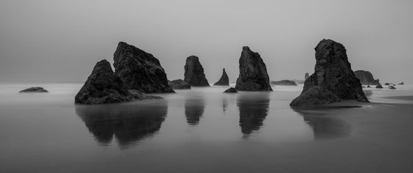 Panoramic view of rocks in sea against clear sky