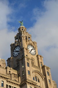 Low angle view of clock tower against sky