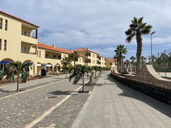 Panoramic view of road amidst buildings against clear sky