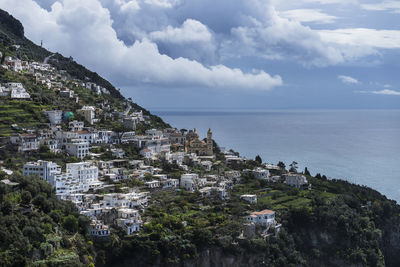 Townscape by sea against sky in city