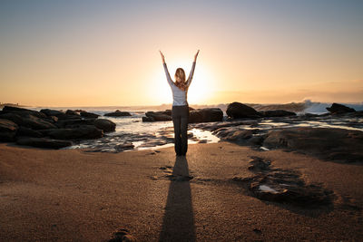 Full length of woman standing on beach