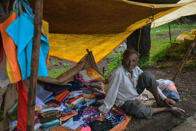 Full length of man sitting at tent