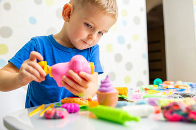 Boy playing with toys on table