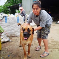 Portrait of man standing with dog