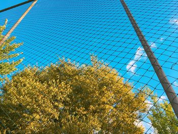 Low angle view of chainlink fence against sky